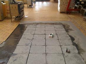 Severly damaged quarry tiles in distillery bottling room